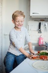 Handsome boy is cooking in the kitchen at home. Healthy food