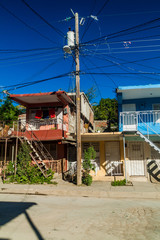 Fototapeta na wymiar Colorful houses and mess of wires in Guantanamo, Cuba