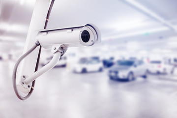 CCTV security camera with car parking background