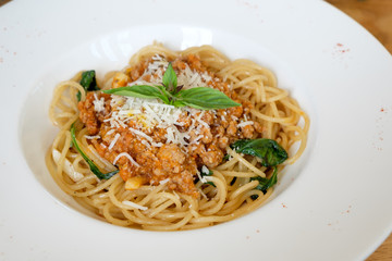spaghetti with meat sauce and basil