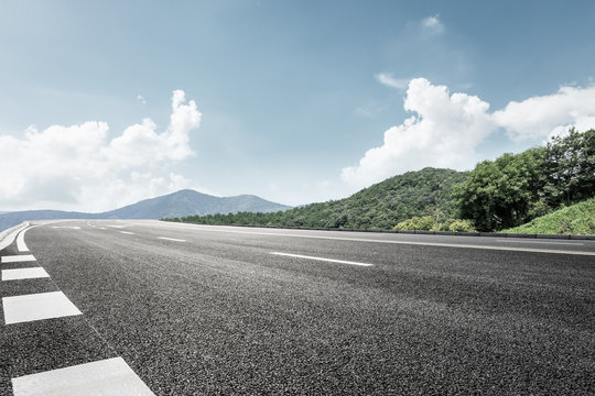 Asphalt Road And Mountain Background