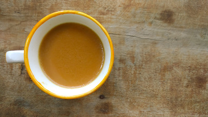 tea in cup with wooden background 