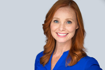 Confident happy positive energetic lively older middle age woman, bright natural smile with red hair