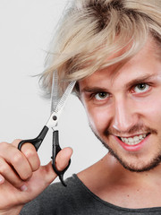 Man with scissors texturizing or thinning shears