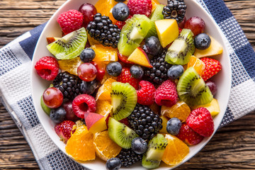 Fruit fresh mixed tropical fruit salad. Bowl of healthy fresh fruit salad - died and fitness concept.