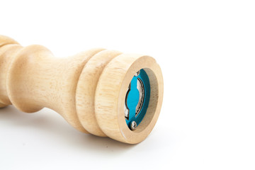 pepper mill of wood with peppercorns