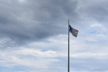 Flag of Newfoundland against a cloudy sky