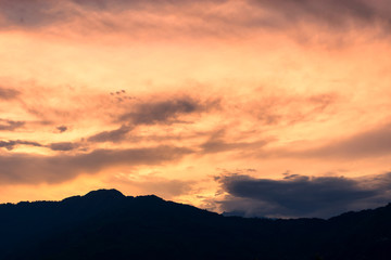 Orange sky, cloud and evening mountains