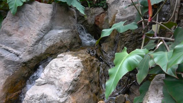 Water falling , flowing down rocks, mountain. Slow motion