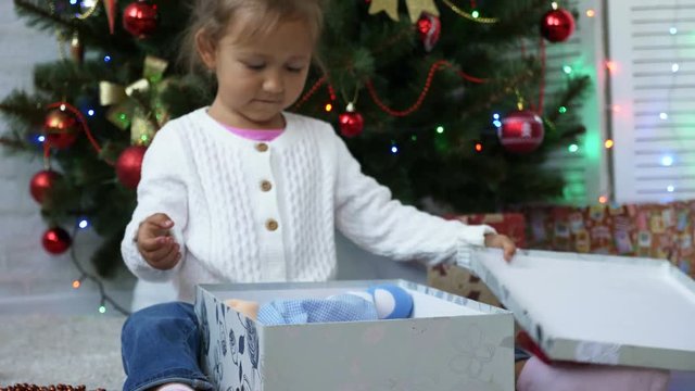 Close up of child opening a Christmas present
