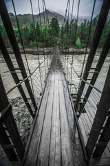 Wooden bridge over a mountain river