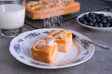 Homemade apricot bouquet with blueberries and a glass of milk like a grandmother