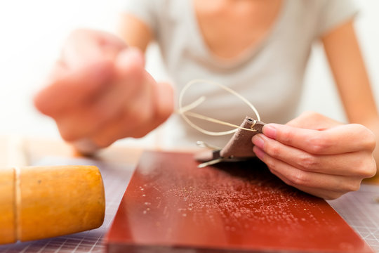 Leather handbag craftsman at work in a workshop