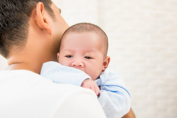 New father holding his adorable little baby