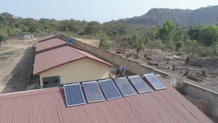 drone view over solar array - aerial over the dry landscape of Guinea, West Africa