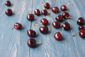 Berries of ripe cherries on a wooden background.
