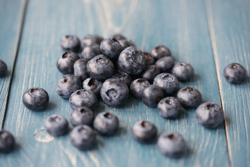 Blueberries on a turquoise wooden background