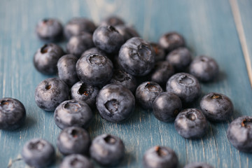 Blueberries on a turquoise wooden background