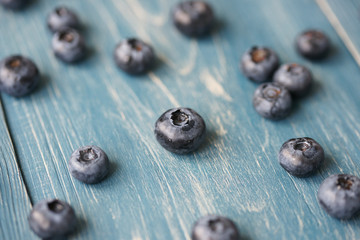 Blueberries on a turquoise wooden background