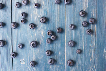 Blueberries on a turquoise wooden background