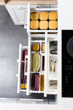 Top View Of Organized Kitchen Drawers And Electric Kitchen Stove. Modern Kitchen Organization Of Spaces.