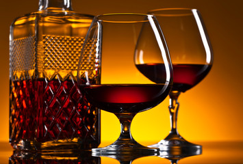  glasses of brandy on the reflective background