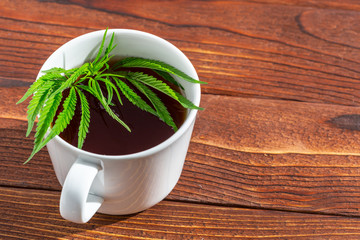 Cannabis herbal tea and marijuana leaves