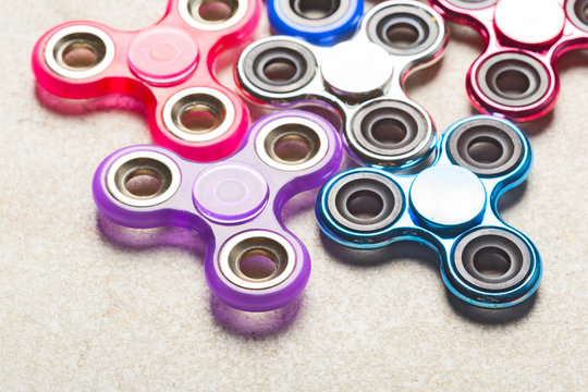 fidget SPINNER stress relieving toy on stone background