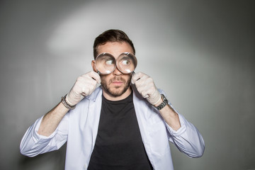 Chemist-a biologist looks through a magnifying glass