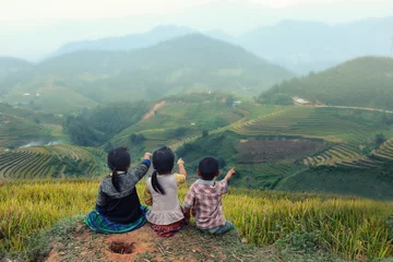 Washable wall murals Mu Cang Chai Three children looking forward on the top of terraced of rice field at Vietnam.Together concept.