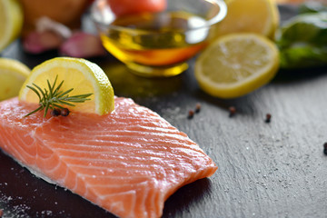 Raw salmon fillets served with lemon