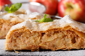 Austrian dessert: homemade apple strudel macro on a slate board. horizontal