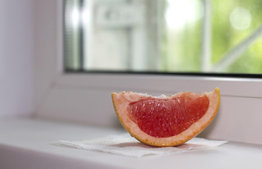 a piece of Juicy bright grapefrukt with seeds and fresh citrus aroma