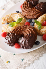 Festive almond and chocolate cookies in the shape of a horseshoe close-up. Vertical