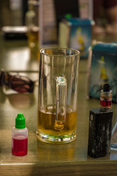 Vaporizer and almost empty beer with bottle and fork on table