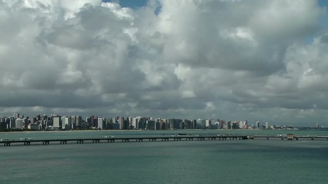 Cityscape of modern buildings at waterfront in Fortaleza, Brazil. Dramatic white clouds on sky