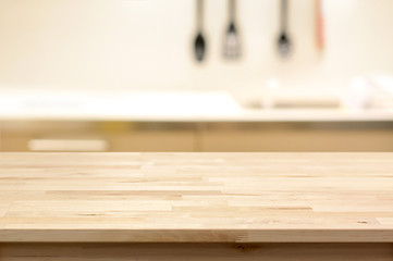 Wood table top (as kitchen island) on blur kitchen background