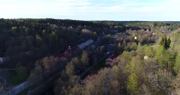 Fiskars village, Cinema 4k aerial view backwards over fiskari steelworks, at a sunny spring day, in Raasepori, Uusimaa, Finland
