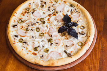 elicious pizza with meat, cheese and mushrooms