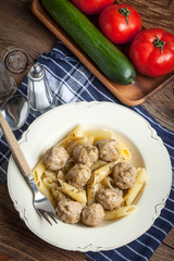 Pork meatballs with dill sauce and pasta. Selective focus.