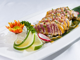 Dish of cooked tuna fish sushi-style, close up