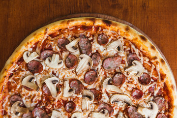 elicious pizza with meat, cheese and mushrooms
