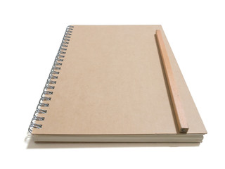 close up of notebook  with new wood pencil isolated on white background