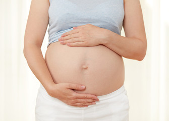 Pregnant woman showing her belly