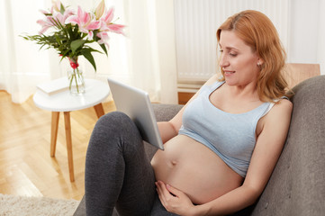 Pregnancy woman relaxing on sofa