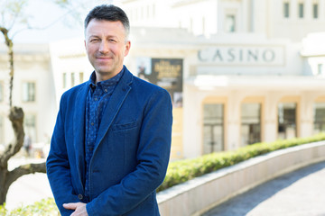 Handsome man. Outdoor male portrait. Middle-aged man, street photo, Biarritz, France.