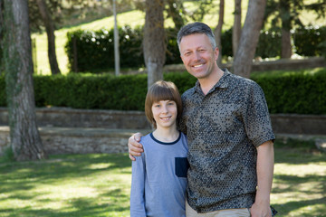 Portrait of father with his son having fun in summer park. Family leisure. Happy boy playing with dad summer nature outdoor