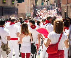 People celebrate San Fermin festival in traditional white abd red clothing with red necktie, 06...