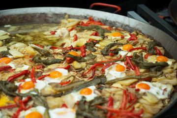 Street food in San Fermin feast, Pamlona, Navarra, Spain. Fried eggs. Scrambled eggs with vegetables. Spanish traditional cuisine. Spanish national dish.