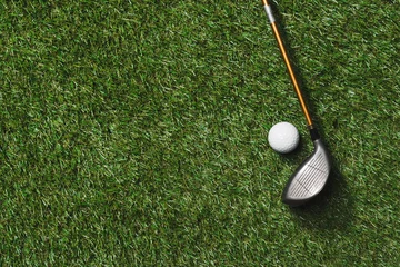 Fototapeten top view of golf club and ball on grass field © LIGHTFIELD STUDIOS